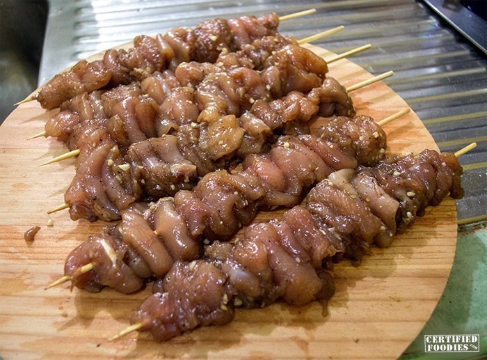 Prepping the chicken yakitori on skewers