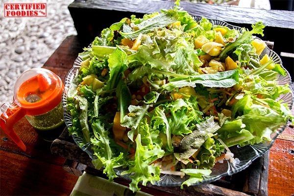 Vegetarian Salad with nuts, mangoes and pesto dressing
